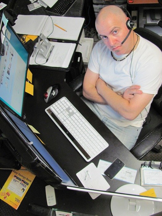 a man works in an office at a laptop