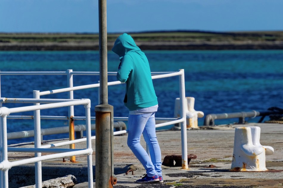 girl on the waterfront on a cold day, orkney island