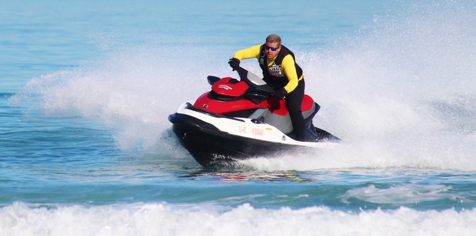 A man on a hydrocycle on a wave