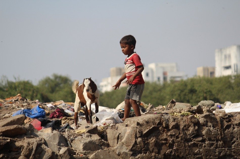 Child with the goat in India