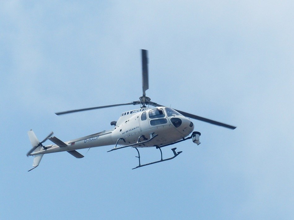 surveillance camera on bottom of helicopter in sky