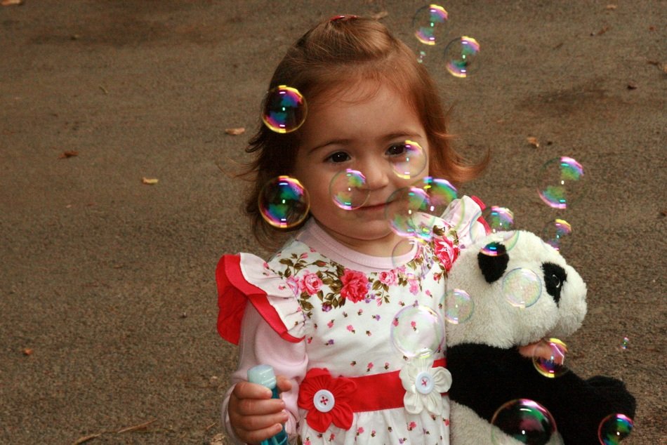 girl blowing a bubbles