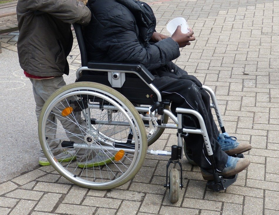 Person on the wheelchair on the pavement