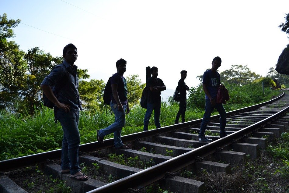 group of guys with guitars on the tracks