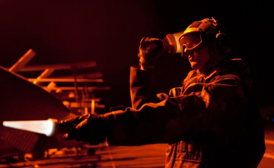 sailor directing aircraft