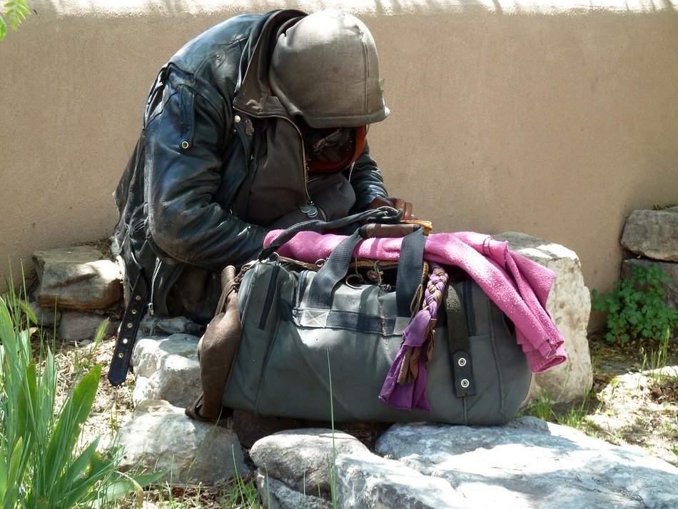 photo of a homeless man with a bag