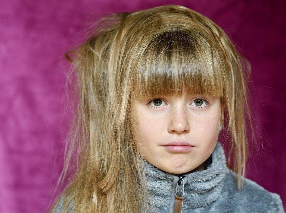 girl with shaggy long hair at purple background