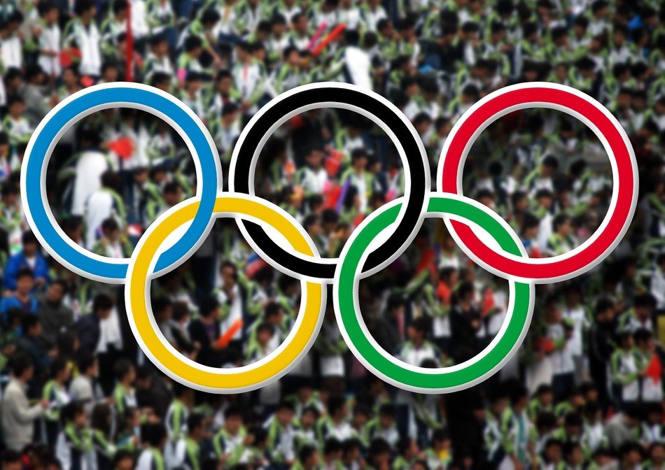 colored olympic rings on the background of people