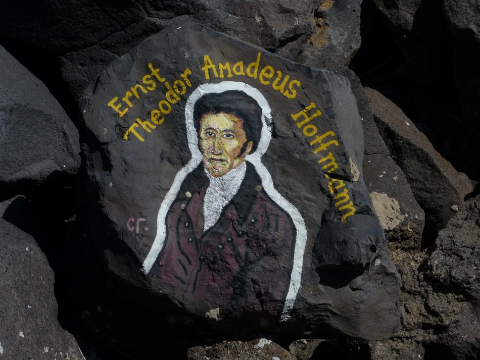 painted musician on black stones of tenerife