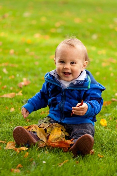 Baby on the grass in autumn