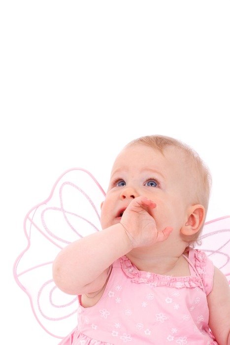 Little girl in pink dress looks up