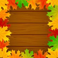 Frame from the leaves on wooden background