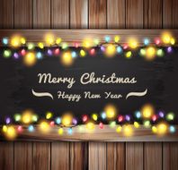 Christmas lights on wooden boards and chalkboard