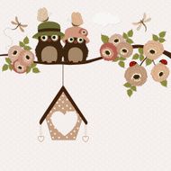 Cute owls on a branch with roses