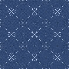 Embroidery with four leaf clovers on dark blue jeans background