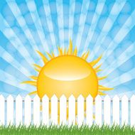 White fence and green grass on blue sky background