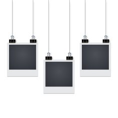 Three photo frames hang on the wall with shadow