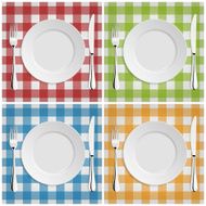 Empty plate with fork and knife at classic checkered tablecloth