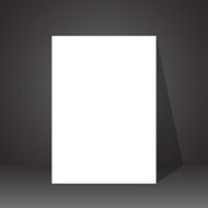piece of paper on the floor with a shadow