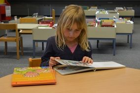 child with a book in the library