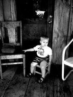 baby sits on a small chair