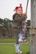 girl in winter clothing on playground