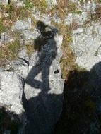 shadow of a man on a rock