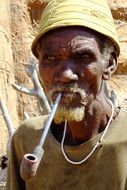 elderly man with a pipe in Africa