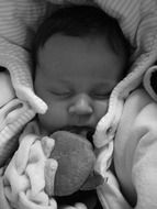 the baby is sleeping in bed