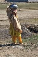 afghan girl carrying water