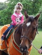 girl sits on a horse