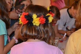 girl with a flower wreath on her head in kindergarten
