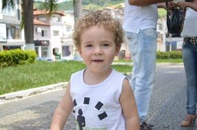 happy child boy with blonde curly hair