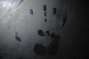 black and white picture of handprint on metal at the crime scene