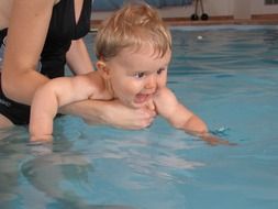 mother with baby in the pool