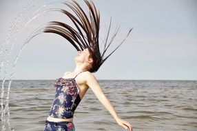 girl with wet hair on the shore