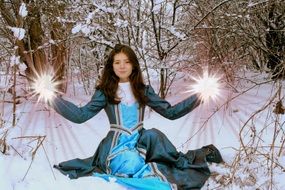 princess in a blue dress on a background of snow