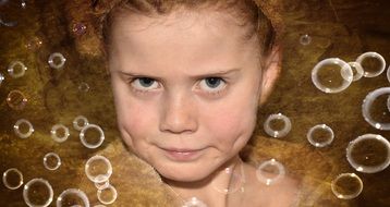 Child in soap bubbles
