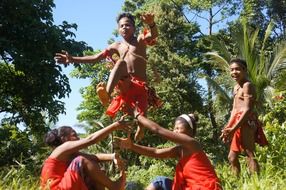 dark skin kids playing among trees