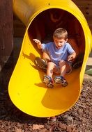 children riding in the yellow slide