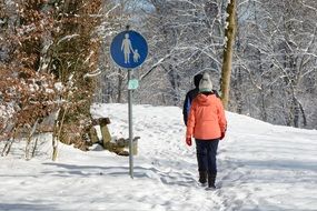 winter hike people on background of the traffic sign
