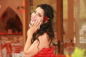 sensuality of the girl with a red rose in her hair
