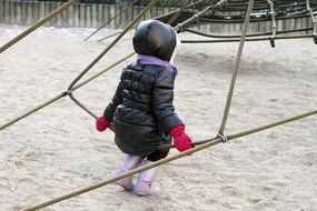 child plays on the Playground in winter