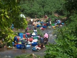 african women washing laundry in river