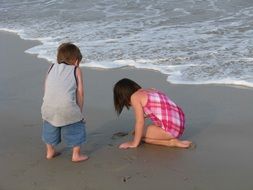 two kids are having fun on the beach