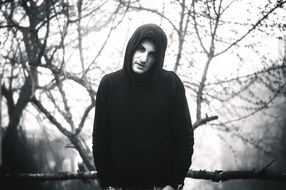 young man in hood outdoor, black and white