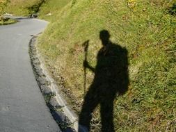 silhouette of a Latino walking along the road