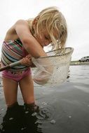 little girl plays in the water