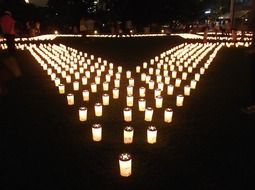 people and many candles in the dark