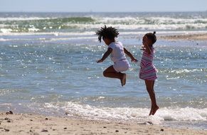 children jump by the sea